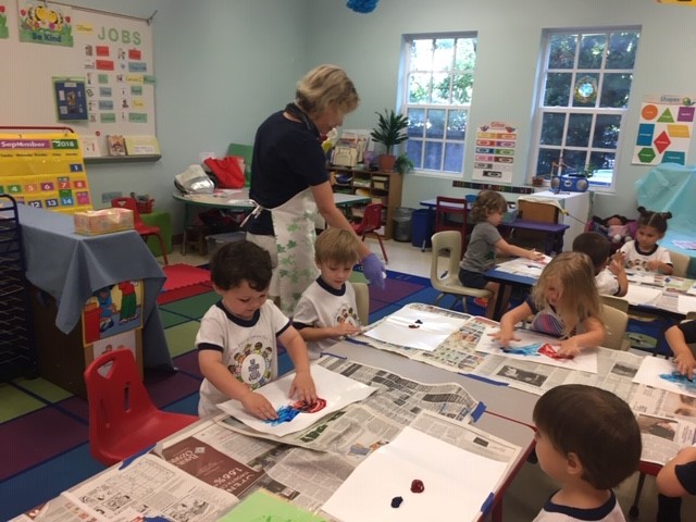 children mixing finger paints