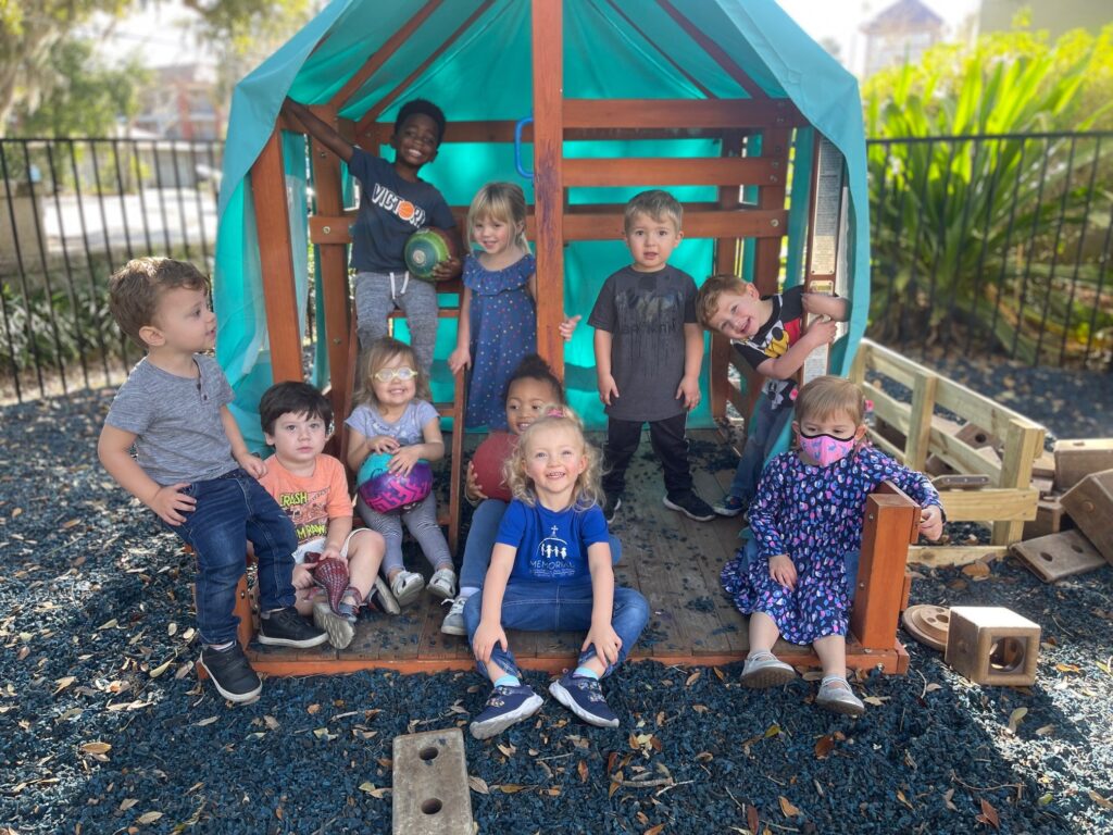 children playing outside in a playhouse