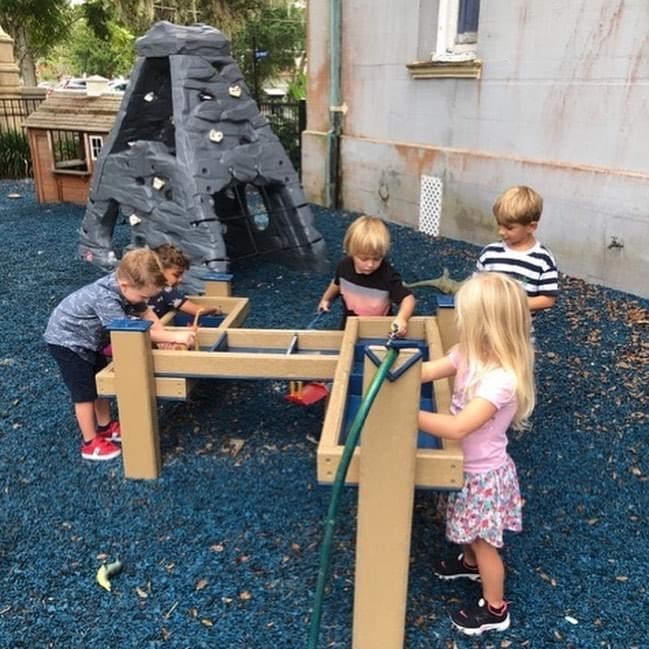 children playing at the water table